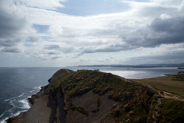 Sky with clouds, sea and land on the coast.