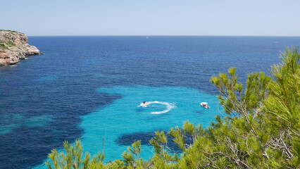 Powerboat circulates in idyllic turquoise reef off the coast