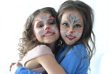 Obraz premium Cute little girls with faces painted posing