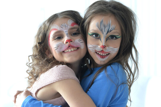 Cute little girls with faces painted posing