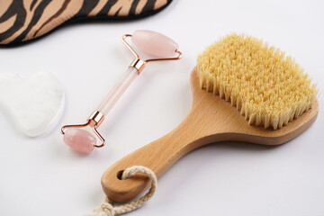 Tools for spa and face wellness cleansing - rose quartz face roller, gua sha massager, brush with...