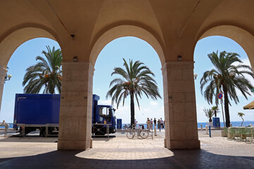 View of the Promenade des Anglais through the ancient arches of old Nice