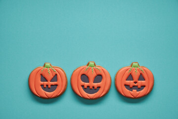 Halloween Gingerbread Cookies on a turquoise background. Top view.
