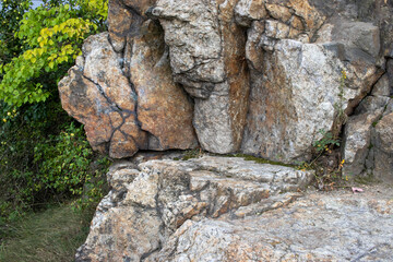 Close-up of stone wall with rocks in the mountains. Granite stone quarry. Autumn, Summer landscape with rocks, and trees. Tourism, travel, vacation concept