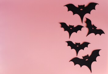five silhouettes of bats on a pink background. Creative halloween concept backdrop. halloween bats...