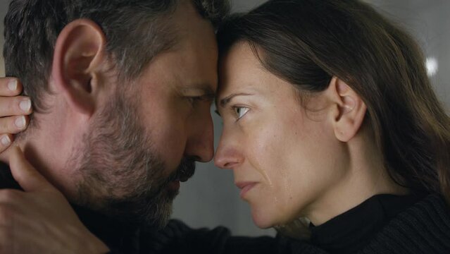 Close-up of woman crying when hugging her husband.