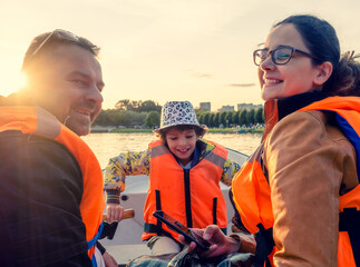 Friendly caucasian family floating on kayak with paddles. Concept of family rest, leisure and...