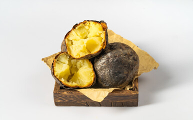 Fresh baked potatoes on a plain white background