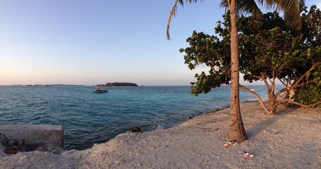 Ferry in turquoise sea off the coast of Maledives