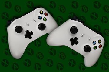 Two gaming gamepads in flight on a dark green background with buttons for games