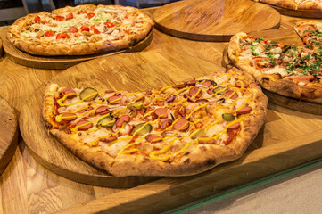 several pizzas with different fillings