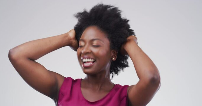 Happy portrait of woman party and dance against a grey studio mockup background. Crazy, funny and young black female has fun dancing to music with an afro hairstyle and happiness moving with rhythm