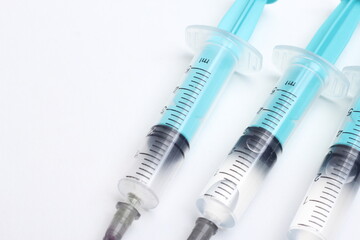 Medical syringe on a white background. A syringe for injection. The concept of health and beauty
