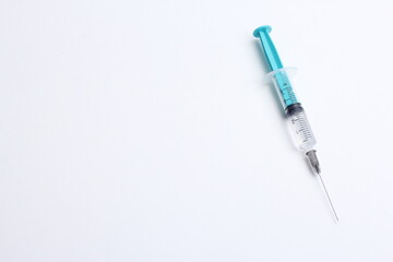 Medical syringe on a white background. A syringe for injection. The concept of health and beauty