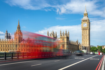 Fototapeta premium Red double decker bus with motion blur on Westminster bridge, Big Ben in the background, in London, UK