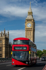 Red double decker bus on Westminster bridge, Big Ben in the background, in London, UK