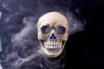 Humans skull with smoke isolated on black background. Death from smoke concept.