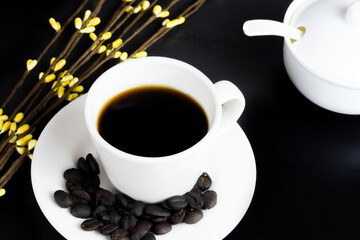 international coffee day, traditional colombian drink, top view of mug of coffee with roasted coffee beans and sugar bowl on black table decorated with flowers