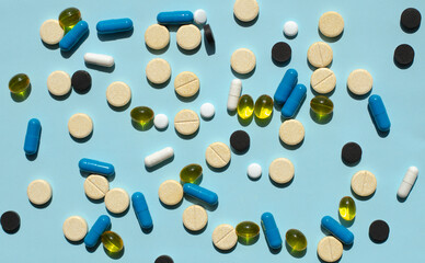 Multi-colored capsules lie on the table. Medicine for illness. Vitamins and biologically active additives. Medicine and healthcare. Genetically modified substances. covit19 pills