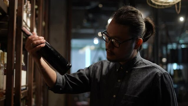 Night club concept of 4k Resolution. The bartender is folded in confidence in the shop. A group of specialized clubs that sell alcoholic beverages.