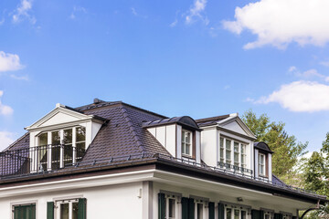 Dormer Windows, Skylight on Residential House, Roof tiles of cottage with dormer windows, drains, slopes, snow retainers. Garret of the house