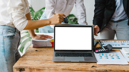 Blank white screen laptop, Close up creative team colleague three business man and women discuss...