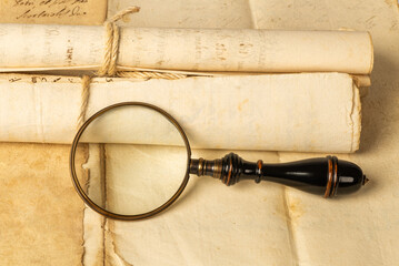 Magnifying glass on old sheets