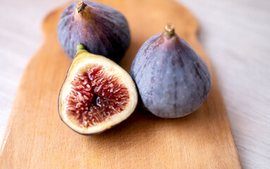 figs on a wooden background. half a fig. Healthy food, useful product. Autumn, harvest