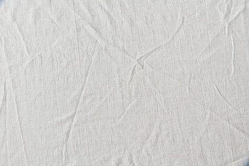 White crumpled linen cloth background.