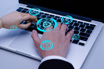 Businessman hand and robot hands show unity with two hands together is working labtop. Concept of Artificial intelligence, technology, join forces, and progress future.