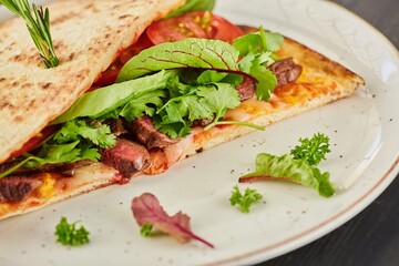 Pita bread filled with meat, vegetables and herbs. Breakfast or lunch. A dish from the chef for serving in a restaurant.