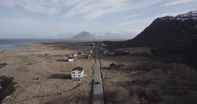 Long road towards the norwegian mountains with small houses
