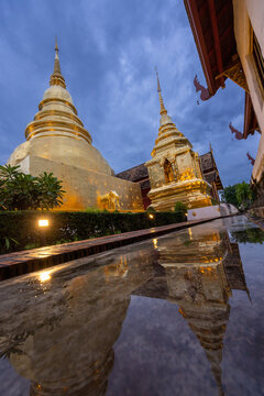Beautiful Golden Royal Monastery in Thailand and reflections on the water surface
