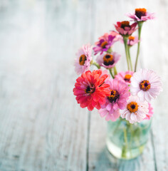 Beautiful colorful flowers over texture rustic background 