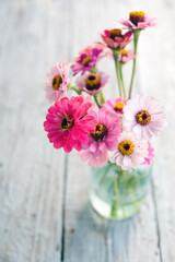 Beautiful colorful flowers over texture rustic background 