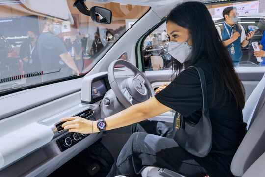 Female visitor check out interior car of Wuling Air ev