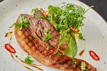 Beef tongue with sauce and herbs. A dish from the chef for serving in a restaurant.