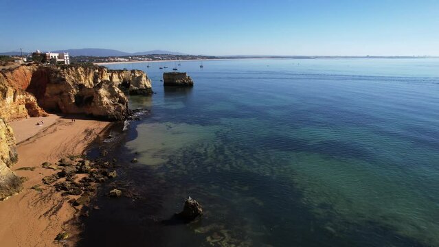 4K Praia Dona Ana beach with turquoise sea water and cliffs, Portugal. Beautiful Dona Ana Beach (Praia Dona Ana) in Lagos, Algarve, Portugal.
