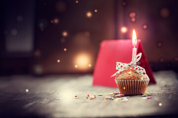 birthdays background , cupcake with candle and present gift over rustic wooden table