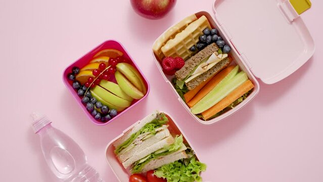Healthy lunch to go. Sandwitches, Fruits and vegetables packed in lunch box