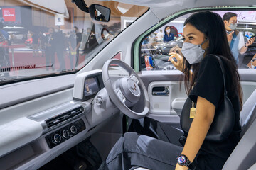 Woman check out interior car of Wuling Air ev