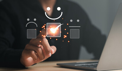 Man touching the virtual screen on the happy Smiley face icon to give satisfaction in service. Customer service evaluation concept.