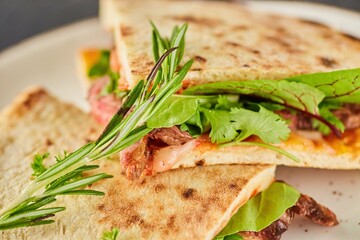 Sandwich with meat, herbs and spices. Breakfast or lunch. A dish from the chef for serving in a restaurant.