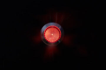 Red alert lamp or warning indicator on black panel glowing. Red alert lamp, status indicator, warning lamp or button. - obrazy, fototapety, plakaty