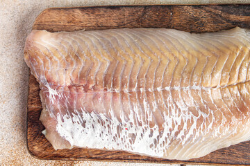 raw saithe fish fillet without bones fresh dish healthy meal food snack diet on the table copy...