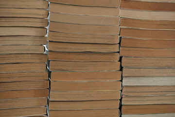 Old manga books, stacked up. Sides of old books in three stacks.