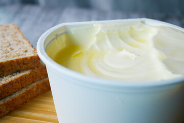 close up of fresh butter in a container 