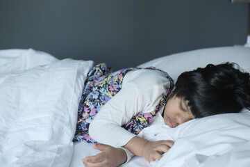 4 year old child girl sleeping on bed 