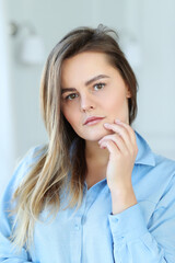 Natural Beauty: Woman Posing for a Selfie with Hands on Her Face, Embracing Her Unique Features
