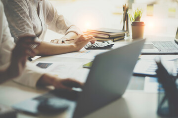 crop shot of business woman checks her work and uses a calculator to calculate her annual financial statements. Turnover and Profit Balance Sheet Making financial records in paper audits.